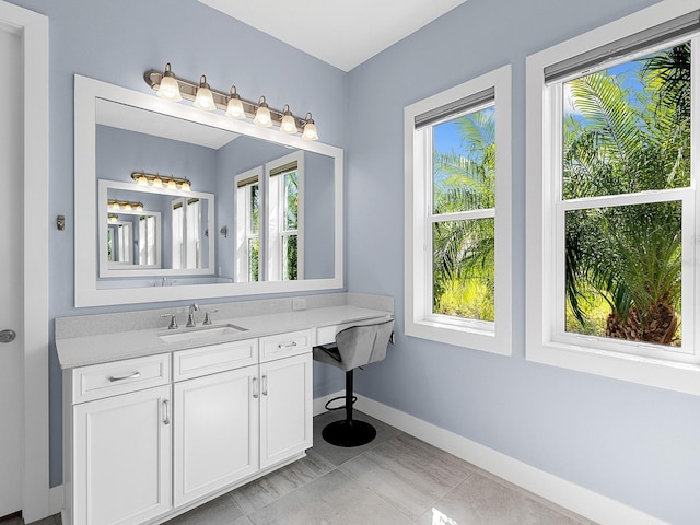 bathroom featuring baseboards and vanity