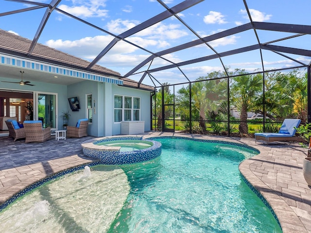 view of swimming pool featuring a ceiling fan, a pool with connected hot tub, a patio, an outdoor hangout area, and a lanai