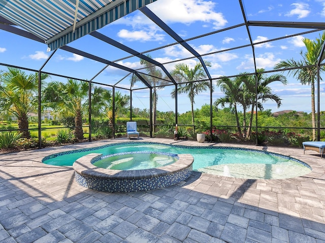 view of swimming pool with a pool with connected hot tub, a lanai, and a patio area