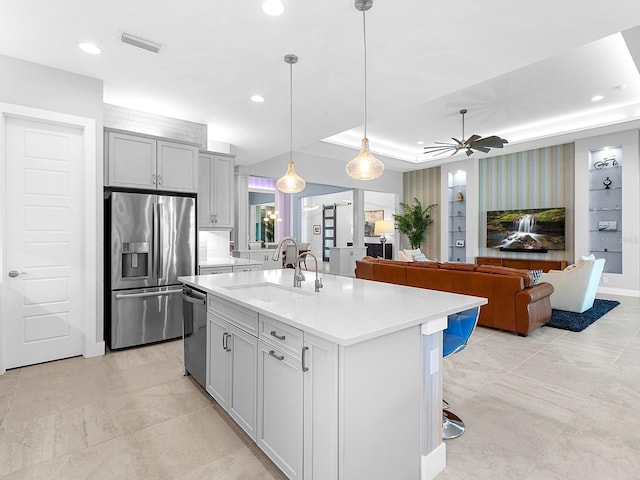 kitchen with visible vents, a sink, light countertops, stainless steel refrigerator with ice dispenser, and dishwasher