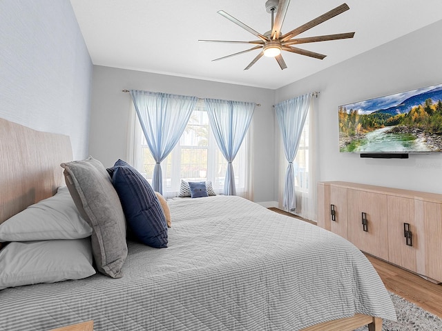 bedroom featuring light wood-style flooring and ceiling fan