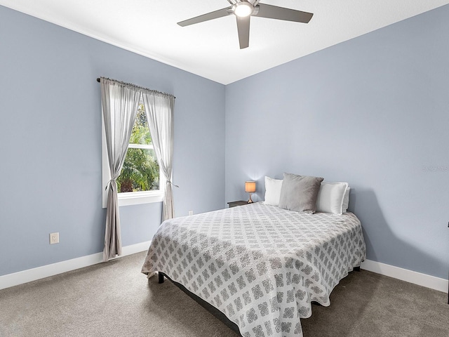 carpeted bedroom with baseboards and ceiling fan