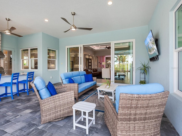 view of patio / terrace with an outdoor living space and ceiling fan