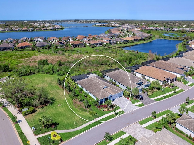 drone / aerial view with a residential view and a water view