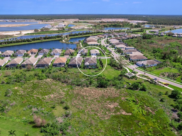 birds eye view of property with a residential view and a water view