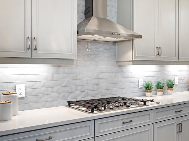 813 Tailwind Pl, Sarasota, FL 34240 - kitchen featuring wall chimney range hood, light countertops, stainless steel gas stovetop, and tasteful backsplash