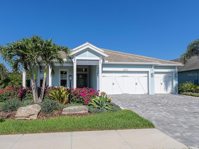 813 Tailwind Pl, Sarasota, FL 34240 - view of front of property with decorative driveway, stucco siding, and a garage