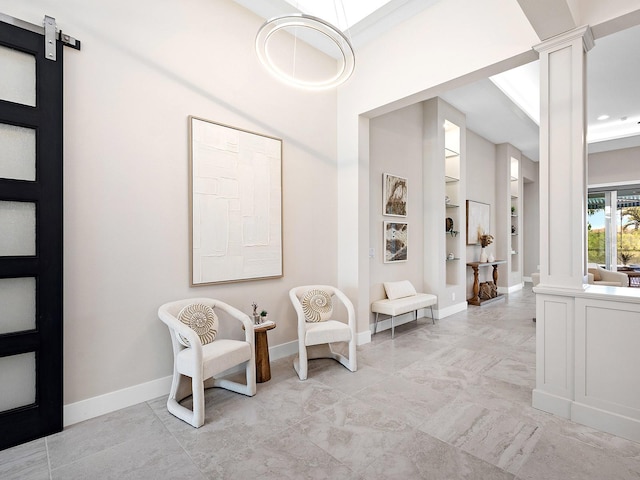813 Tailwind Pl, Sarasota, FL 34240 - sitting room featuring ornate columns, built in shelves, and baseboards