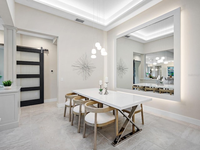 813 Tailwind Pl, Sarasota, FL 34240 - dining area featuring a raised ceiling, a barn door, baseboards, and ornate columns