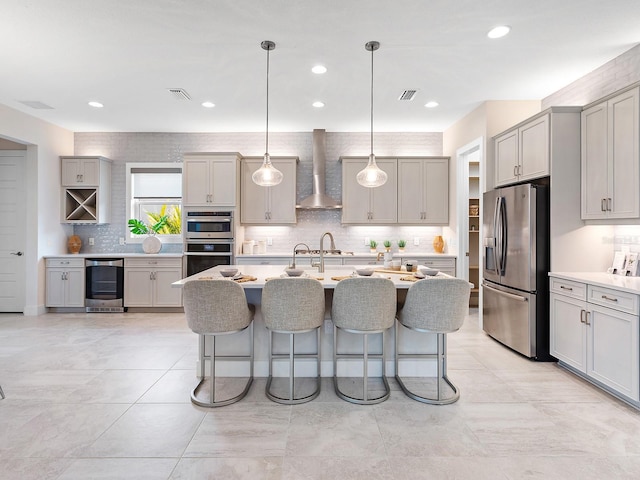 813 Tailwind Pl, Sarasota, FL 34240 - kitchen with stainless steel appliances, beverage cooler, wall chimney range hood, gray cabinets, and recessed lighting