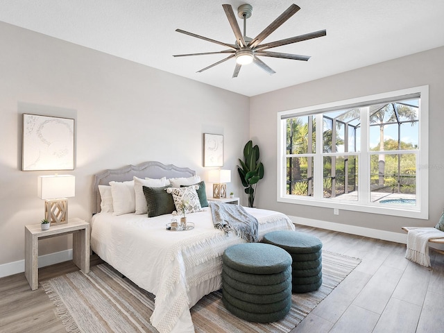 813 Tailwind Pl, Sarasota, FL 34240 - bedroom with baseboards, light wood-type flooring, and ceiling fan