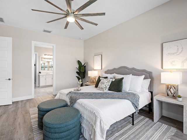 813 Tailwind Pl, Sarasota, FL 34240 - bedroom featuring light wood-style floors, baseboards, ensuite bath, and a ceiling fan
