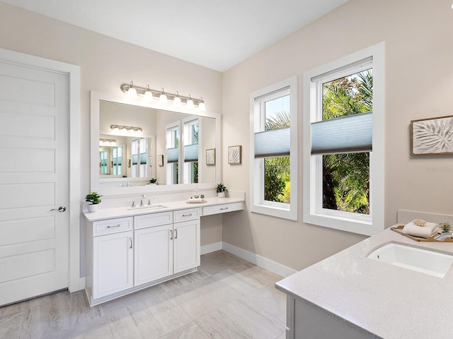 813 Tailwind Pl, Sarasota, FL 34240 - full bathroom featuring two vanities, baseboards, and marble look tiles