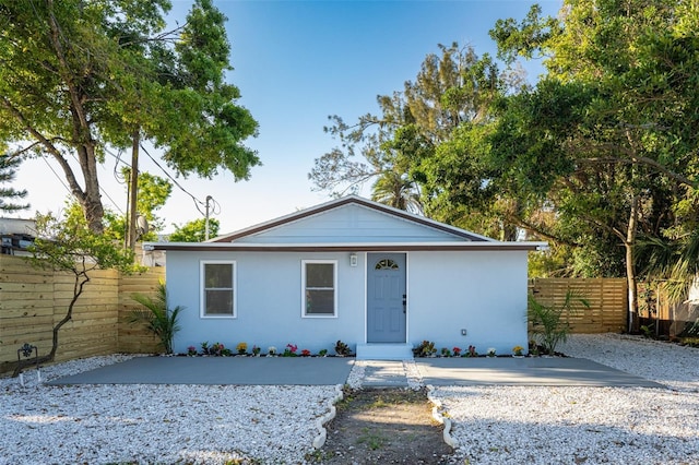 view of front of house with driveway and fence