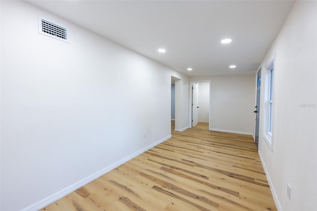 hall with baseboards, recessed lighting, visible vents, and light wood-type flooring