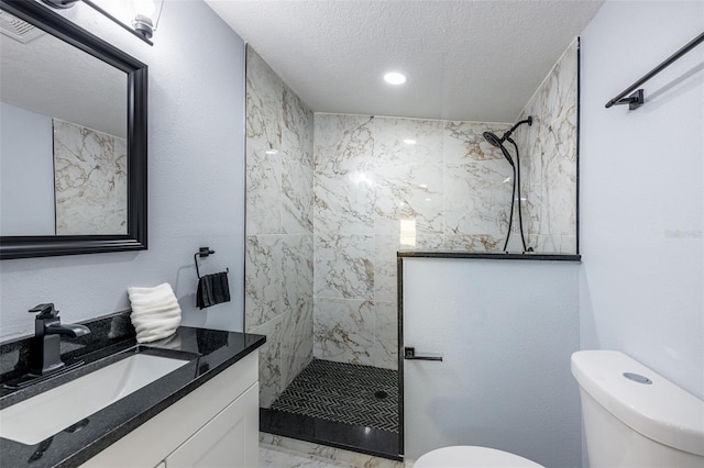 bathroom featuring a textured ceiling, toilet, marble finish floor, and a walk in shower