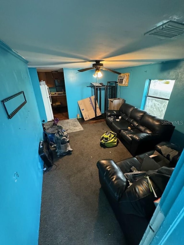 living room featuring visible vents, carpet flooring, and a ceiling fan