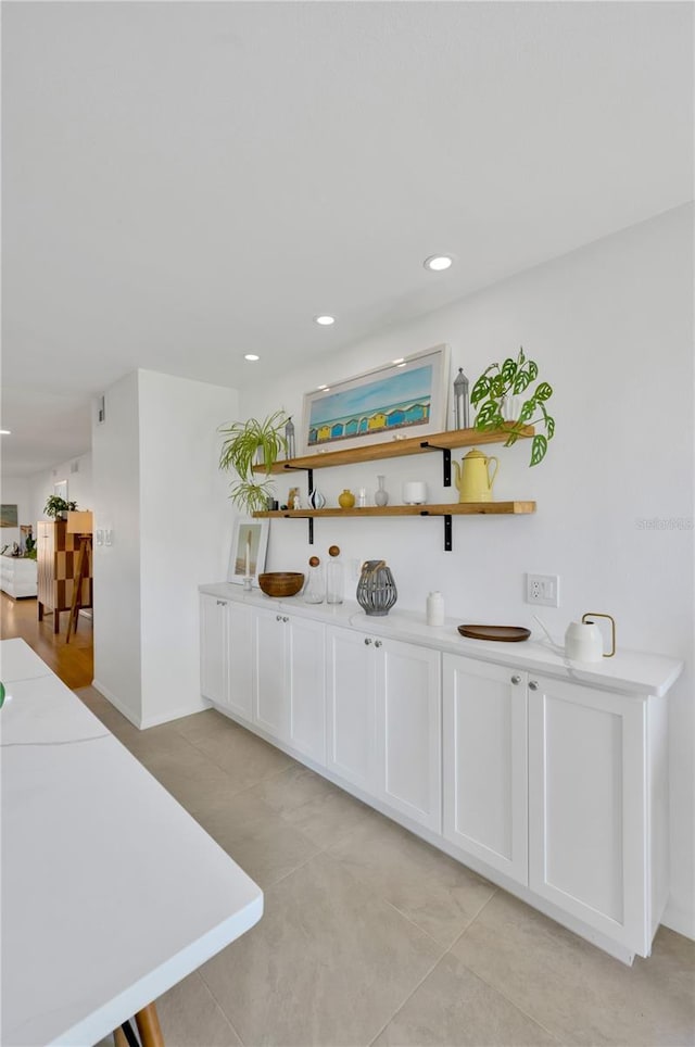 kitchen featuring light tile patterned floors, open shelves, recessed lighting, light countertops, and white cabinets