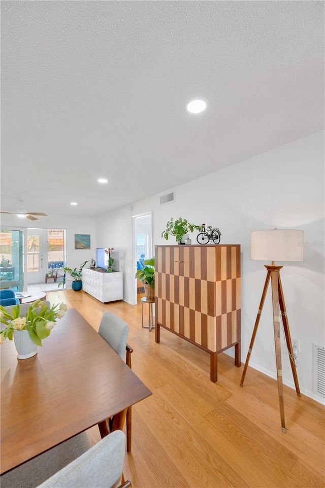 dining room featuring visible vents, plenty of natural light, and light wood-style flooring