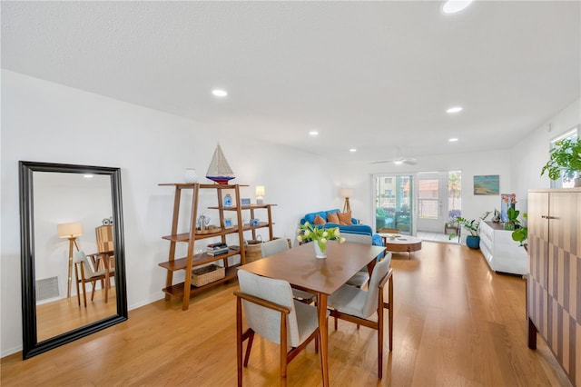 dining space featuring light wood finished floors, visible vents, and recessed lighting