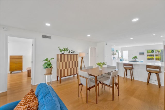 dining room featuring light wood finished floors, visible vents, and recessed lighting