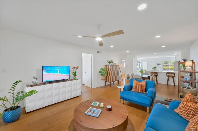 living room with recessed lighting, visible vents, ceiling fan, and wood finished floors