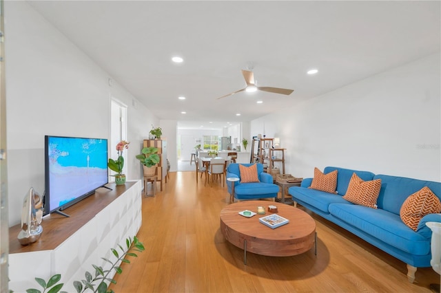 living area with ceiling fan, light wood-style flooring, and recessed lighting