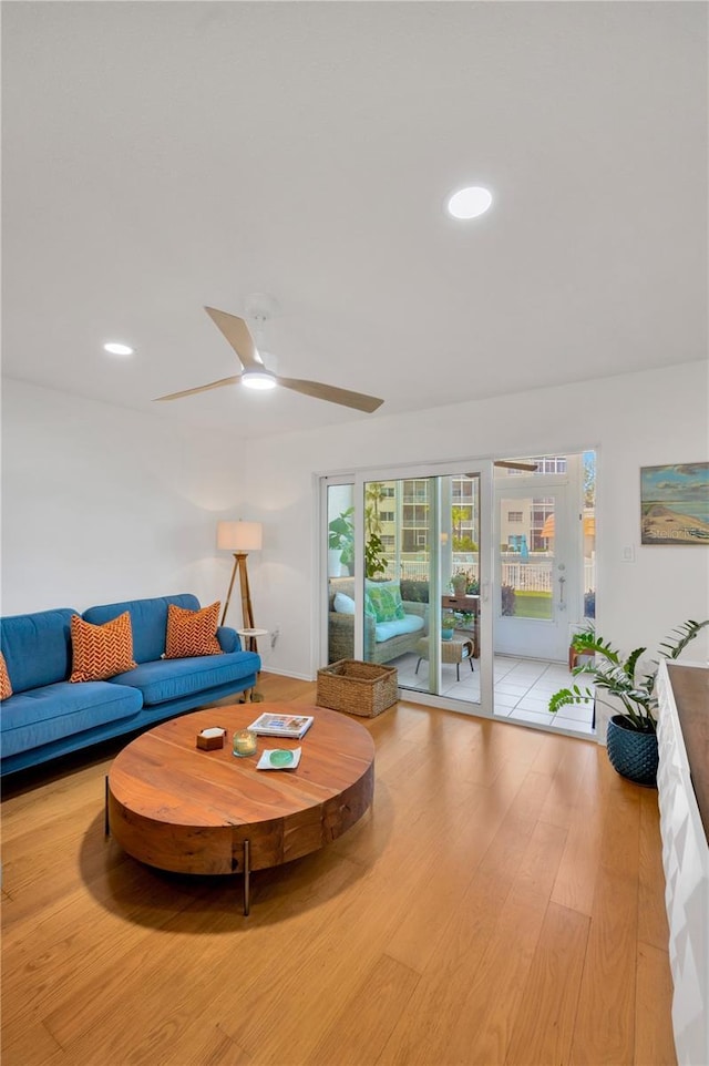 living area with wood finished floors, a ceiling fan, and recessed lighting