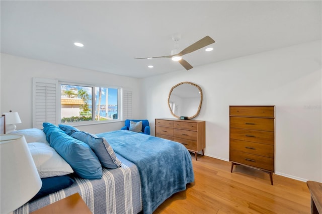 bedroom with baseboards, ceiling fan, light wood-type flooring, and recessed lighting