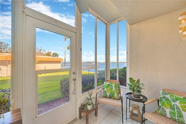 sunroom featuring lofted ceiling and a water view