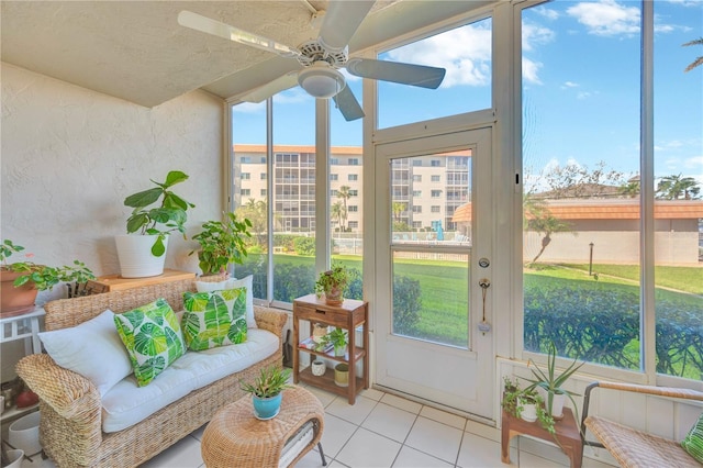 sunroom featuring plenty of natural light and a ceiling fan