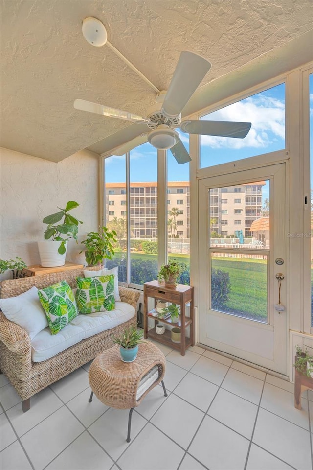 sunroom featuring a ceiling fan