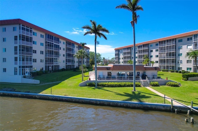 view of property's community featuring a water view and a yard