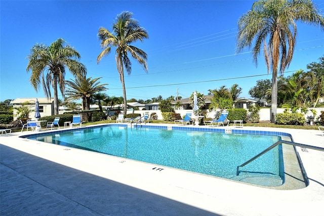 community pool featuring a patio and fence