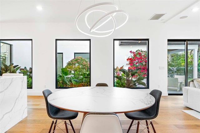 dining space featuring light wood finished floors, visible vents, and recessed lighting