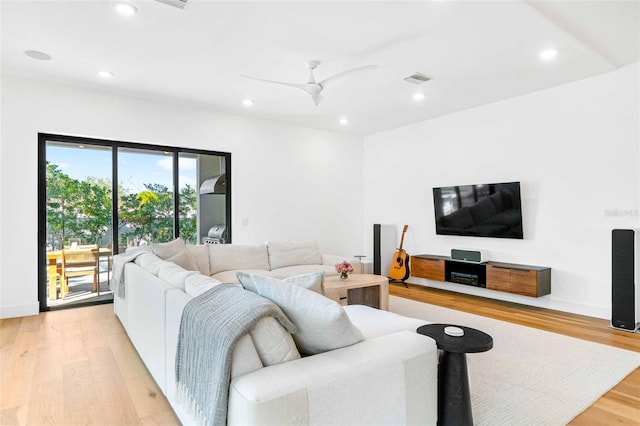 living area with recessed lighting, ceiling fan, light wood-style flooring, and baseboards