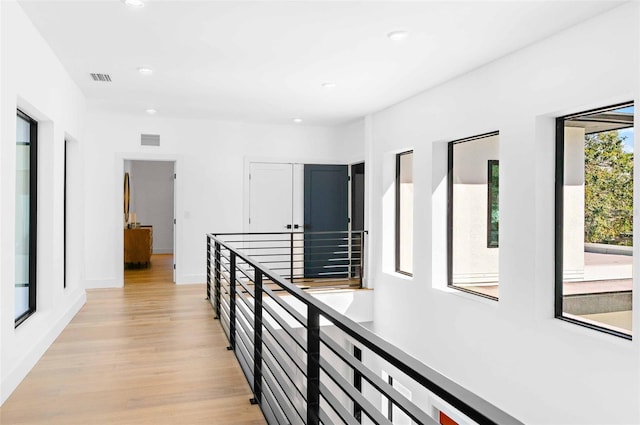 hall with baseboards, light wood-style flooring, visible vents, and recessed lighting