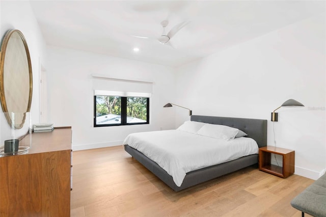 bedroom featuring recessed lighting, ceiling fan, light wood-style flooring, and baseboards