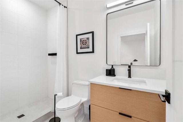 bathroom featuring toilet, a stall shower, and vanity