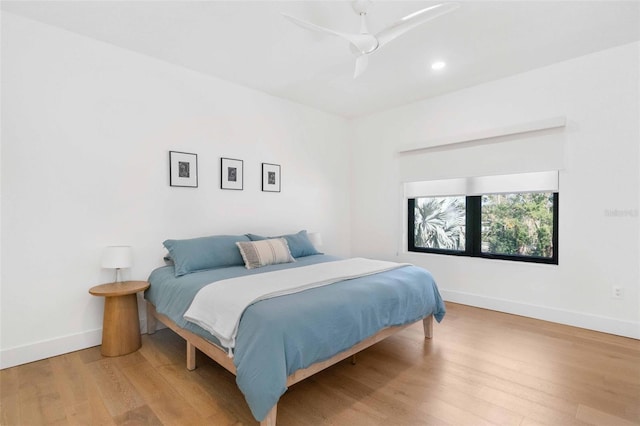 bedroom with ceiling fan, recessed lighting, wood finished floors, and baseboards