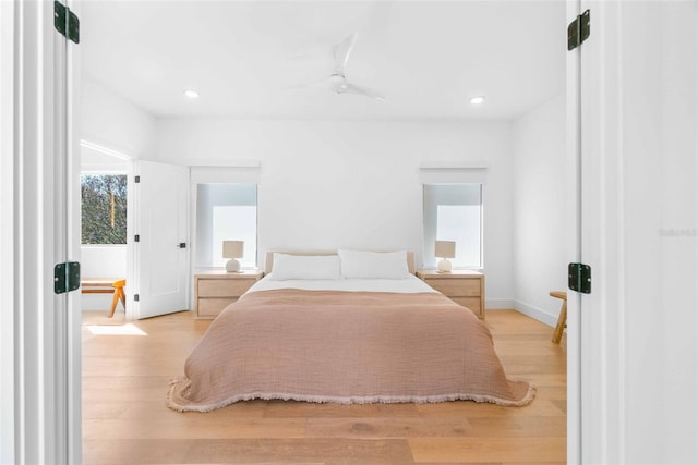 bedroom featuring a ceiling fan, baseboards, wood finished floors, and recessed lighting