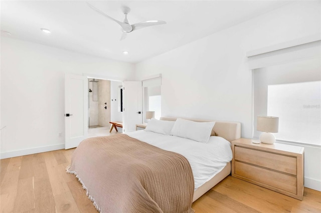 bedroom with light wood-style floors, ceiling fan, and baseboards