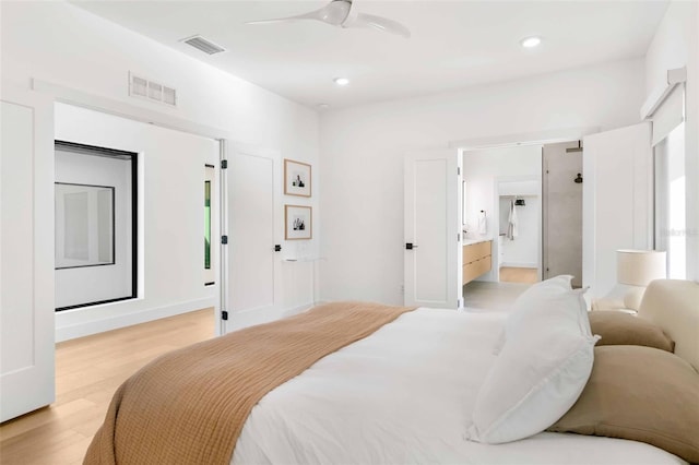 bedroom with light wood-type flooring, visible vents, ensuite bathroom, and recessed lighting