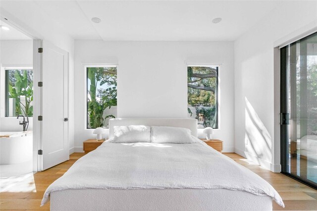 bedroom with light wood-style flooring and baseboards