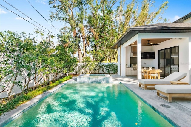 view of pool with ceiling fan, a patio, a fenced backyard, area for grilling, and a pool with connected hot tub