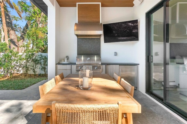 view of patio featuring an outdoor kitchen and a grill