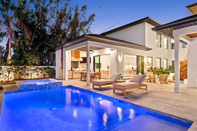 view of swimming pool featuring a ceiling fan, a pool with connected hot tub, a patio area, and area for grilling