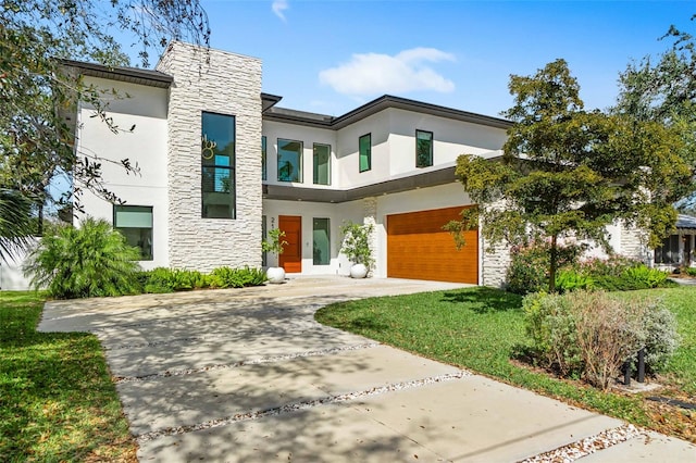 contemporary home with stucco siding, stone siding, and concrete driveway
