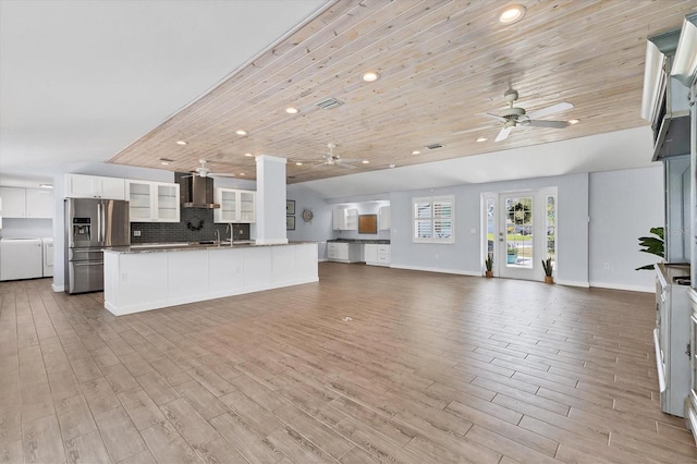 unfurnished living room with wooden ceiling, a sink, and wood finished floors