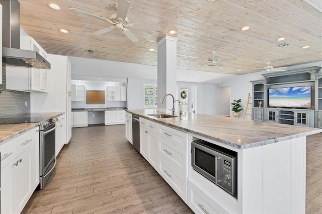 kitchen with tasteful backsplash, wooden ceiling, appliances with stainless steel finishes, wall chimney range hood, and a sink